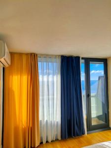 a room with two curtains and a window at Orbi City in Batumi in Batumi