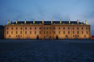 a large tan building with a dark roof at Joli studio avec parking privé in Moulins
