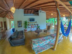 a living room with couches and a hammock at Kallpa B&B in Palomino
