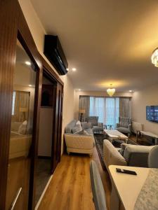 a living room with a couch and a table at Lux 2+1 apartment in Başakşehir ISTANBUL in Basaksehir