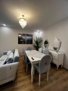 a dining room with a table and chairs and a couch at Lux 2+1 apartment in Başakşehir ISTANBUL in Basaksehir