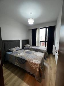 a bedroom with two beds and a window at Lux 2+1 apartment in Başakşehir ISTANBUL in Basaksehir