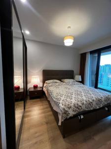 a bedroom with a bed and a large window at Lux 2+1 apartment in Başakşehir ISTANBUL in Basaksehir