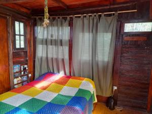 a bedroom with a colorful blanket on a bed at Selva Nuez in San Antonio