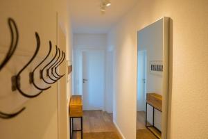 een kamer met een hal met een spiegel en een tafel bij Ferien in Neviges in Velbert