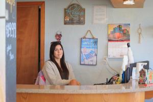 a woman sitting at a counter in a room at Tropic Island Resort in Port Aransas