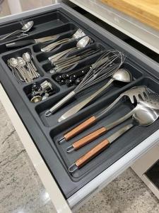 a drawer filled with lots of utensils in a kitchen at La Baita Contemporanea; mix tra passato e presente in Prato