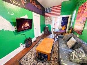 a living room with a couch and a tv at ITH Adventure Hostel San Diego in San Diego