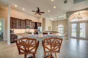 una grande cucina con tavolo e due sedie di Villa Blue Pavilion - Heated Pool - Sleeps 16 - Roelens Vacations a Cape Coral