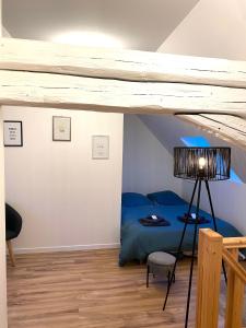 1 dormitorio con 1 cama azul en el ático en Duplex moderne à 10 minutes de Colmar, en Wintzenheim