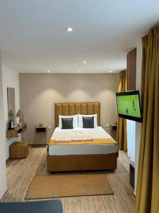 a bedroom with a bed and a flat screen tv at Comfort Hotel in Struga