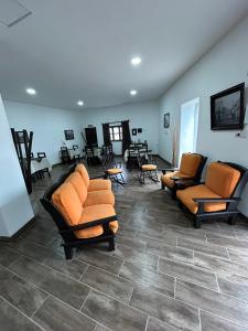 a waiting room with couches and chairs and tables at Hotel del Tren in Salta