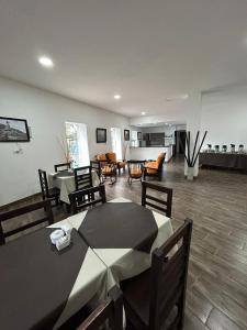 a dining room with tables and chairs and a living room at Hotel del Tren in Salta