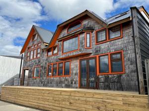 a house with orange accents on it at Hotel Boutique Arca Restaurant Achao Quinchao Chiloe in Achao