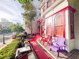 a house with red and purple chairs on the porch at ITH Adventure Hostel San Diego in San Diego