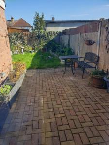 a patio with a table and a bench in a backyard at Mesa property services in Grays Thurrock