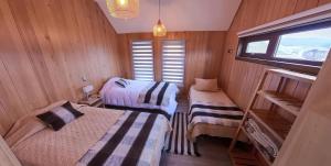 Ein Bett oder Betten in einem Zimmer der Unterkunft Hotel Boutique Arca Restaurant Achao Quinchao Chiloe
