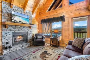 a living room with a fireplace in a cabin at A Higher Calling, 1089 of FREE area attraction tickets for each paid day, Dollywood and More! in Pigeon Forge