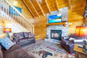 a living room with couches and a fireplace at A Higher Calling, 1089 of FREE area attraction tickets for each paid day, Dollywood and More! in Pigeon Forge