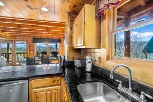 a kitchen with a sink and a counter top at A Higher Calling, 1089 of FREE area attraction tickets for each paid day, Dollywood and More! in Pigeon Forge