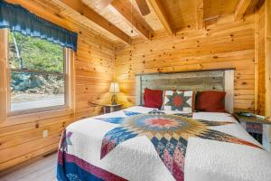a bedroom with a bed in a log cabin at A Higher Calling, 1089 of FREE area attraction tickets for each paid day, Dollywood and More! in Pigeon Forge