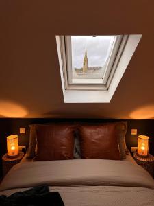 a bedroom with a bed with a window above it at CHAMBERS RISE - City Centre Stays in Derry Londonderry