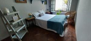 a bedroom with a bed with a blue blanket on it at Los Aceres in Salta +1 photo