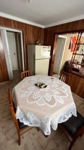 a table with a white table cloth on top of it at “Chalet Carrasco” totalmente equipado in Mar del Plata