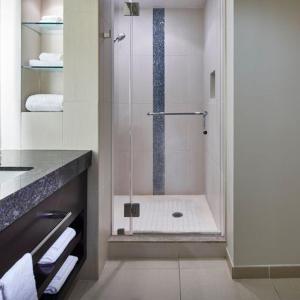 a bathroom with a shower with a glass door at Harrah's Cherokee Casino Resort in Cherokee
