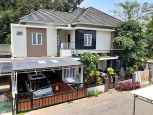 a house with a car parked in front of it at TITE homestay. Staycation feels @home in Salakan