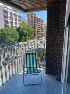 una silla verde y azul sentada en un balcón en Fontinalis Hosting Perla en Mar del Plata