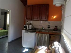 a kitchen with a person laying on the floor at El Zohar 4 pax in Federación +8 photos