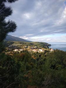 a view of a town on a hill near the water at Villa Gialos Rooms in Kokkino Nero