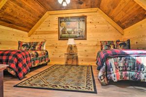 a log cabin bedroom with two beds and a rug at Hot Springs Cabin Rental 2 Mi to Lake Hamilton! in Hot Springs