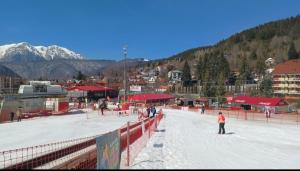 a group of people skiing on a snow covered slope at Nova Montan Azuga in Azuga