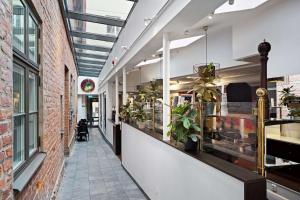 a corridor of a building with plants on the walls at Best Western Plus Hotell Nordic Lund in Lund