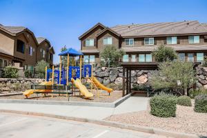 a playground with a slide in front of a house at Coral Ridge 4266 Desert Retreat in Washington