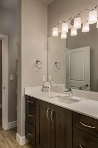 a bathroom with a sink and a large mirror at S301-Hilltop Hideaway-Third Floor 3-bedroom Pool View in St. George