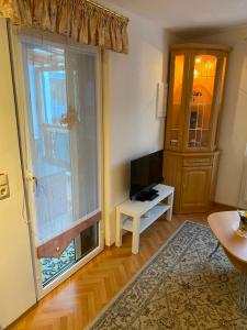 a living room with a large window and a television at Ferienhaus Greiz in Greiz