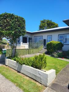 a house with a garden in front of it at Totara Lodge Motel in Levin