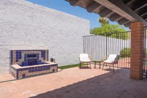 a patio with two chairs and a fireplace at Spacious Arcadia Lite house w pool mtn views in Phoenix