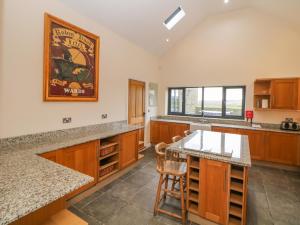 a kitchen with wooden cabinets and a counter top at The Old Robin Hood in Holmesfield