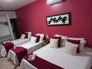 מיטה או מיטות בחדר ב-Pousada Primavera