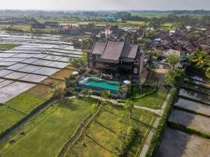 an aerial view of a house with a swimming pool at Royal Roco Villa in Tanah Lot