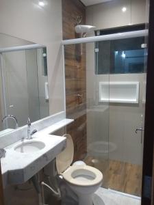 a bathroom with a toilet and a sink and a shower at Chalé Boa Vista in Ilhabela