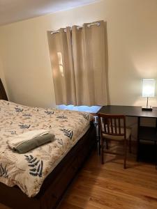 a bedroom with a bed and a desk and a table at M1 Queen Size BedRoom with desk near Rutgers U & hospitals in New Brunswick