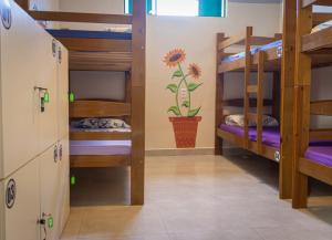 a room with bunk beds in a hostel at Massambaba Hostel in Arraial do Cabo