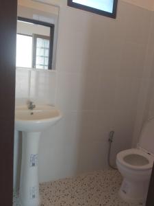 a bathroom with a sink and a toilet at Nice Home Stay @Samroiyot in Sam Roi Yot