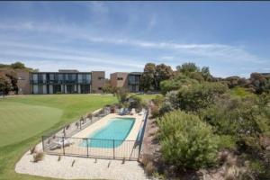 an aerial view of a house with a swimming pool at Moonah Links Apartment 45 Lovely 1 bedroom holiday home with heated pool in Fingal