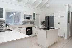 A kitchen or kitchenette at House Of The Sun Vacation Home No 1